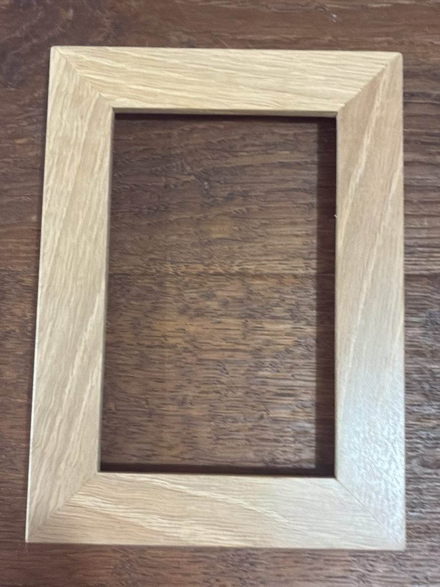 A quartersawn oak picture frame showing shimmering ray fleck figure across its face.