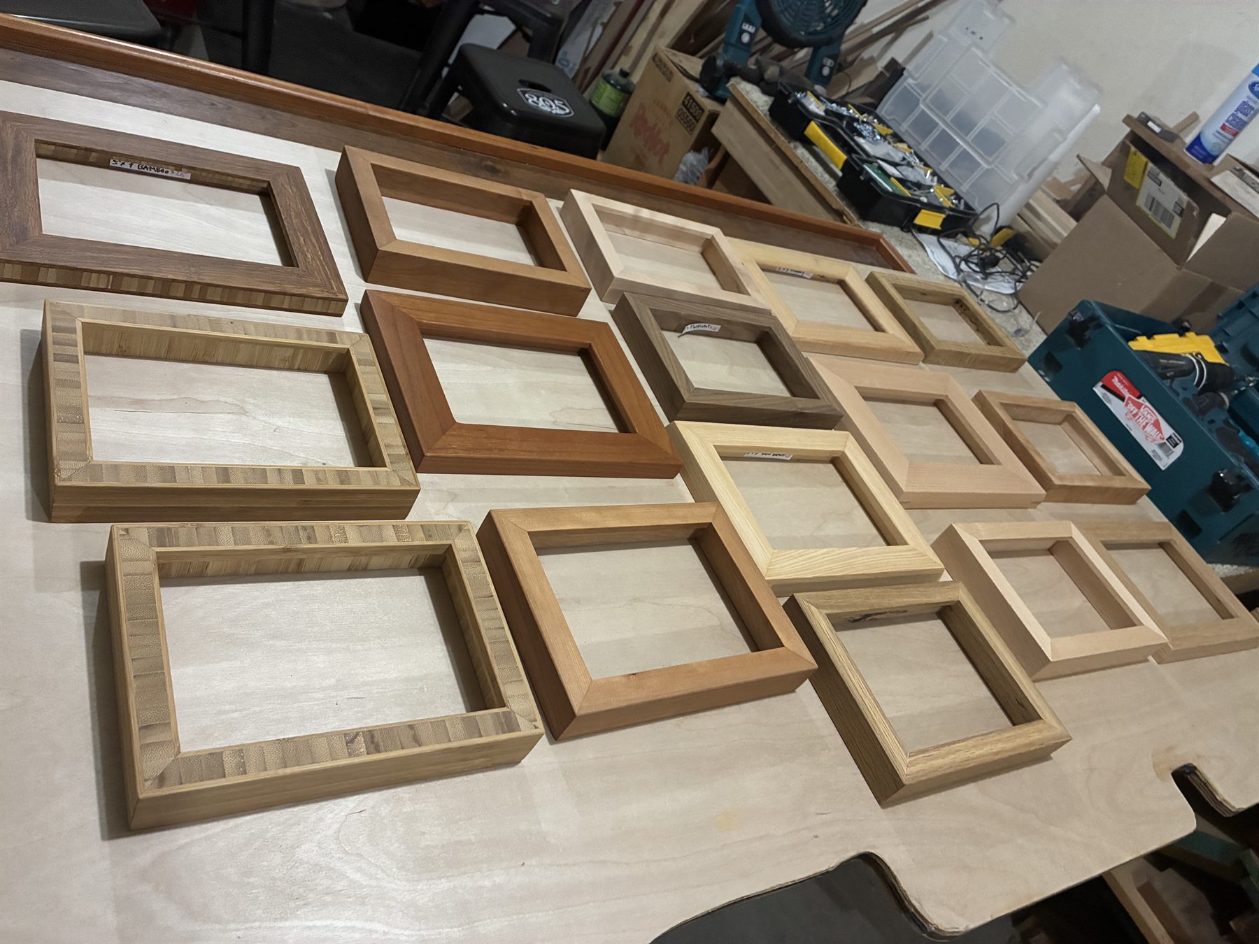 Picture frames including three made from striped edge-grain bamboo, beside cherry and oak frames.